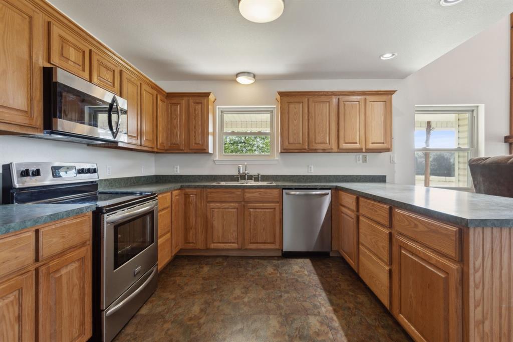 1133 VZ County Road Canton, TX 75103 - Photo 10 of 38 a kitchen with stainless steel appliances granite countertop a sink stove and cabinets