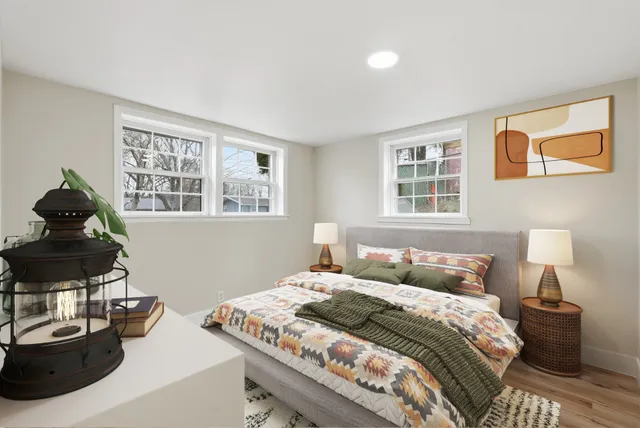 a bedroom with a bed and wooden floor