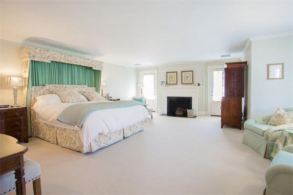 122 Monadnock Road Newton, MA 02467 - Photo 11 of 18 a bedroom with a bed and a fireplace