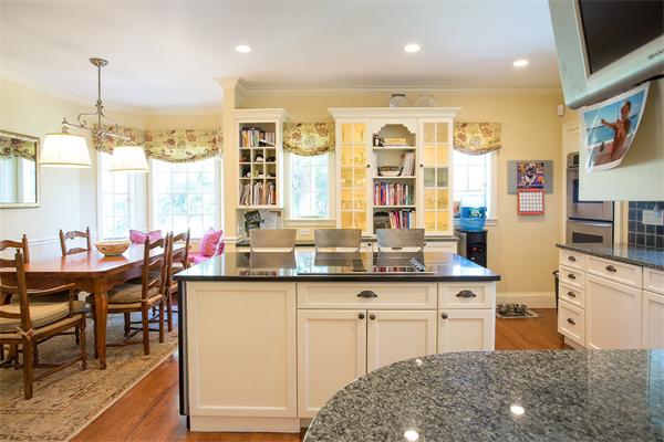 122 Monadnock Road Newton, MA 02467 - Photo 7 of 18 a kitchen with stainless steel appliances granite countertop a table chairs sink and cabinets