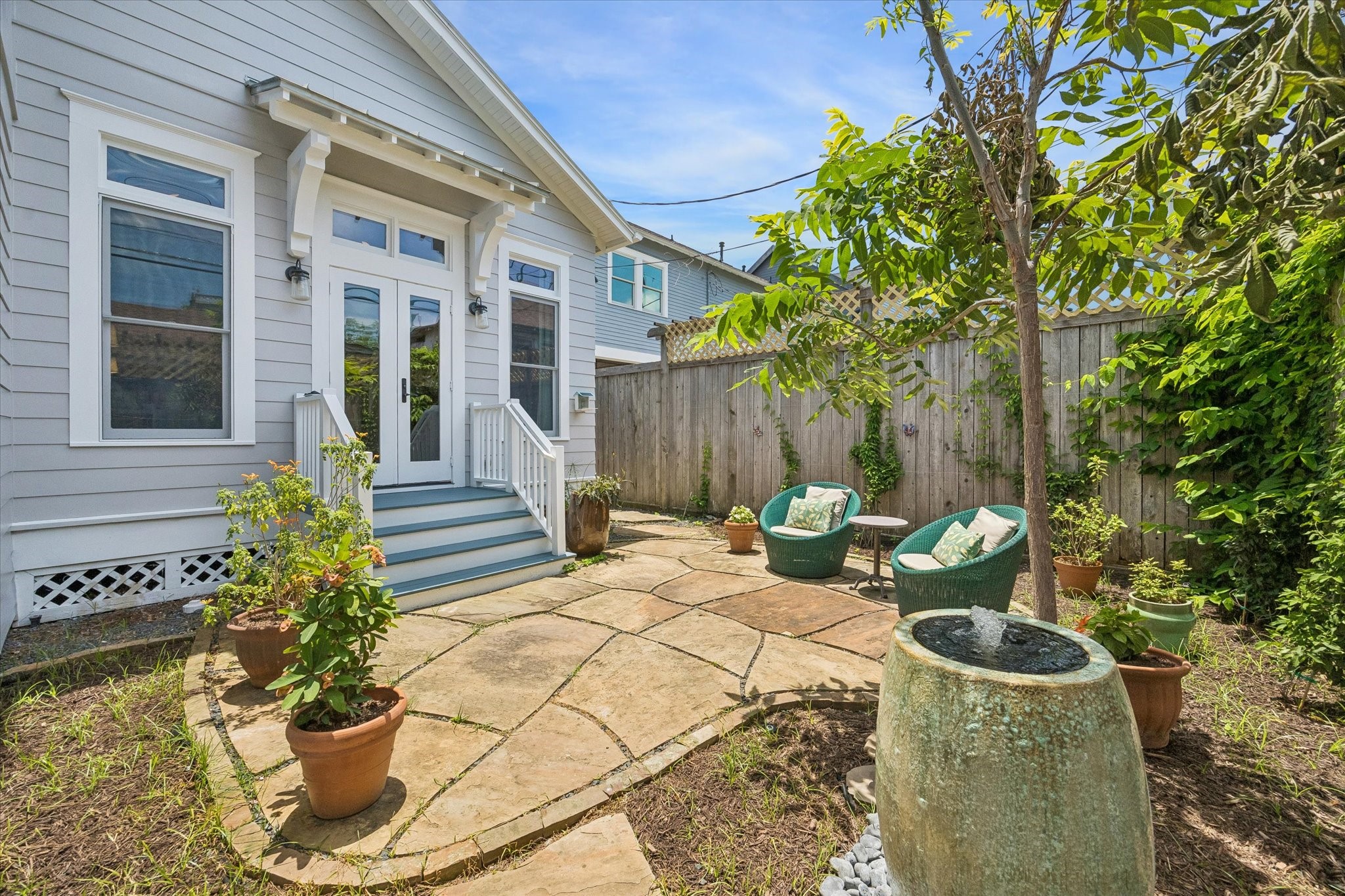1101 Omar Street Houston, TX 77009 - Photo 20 of 46 A tranquil private courtyard with soothing water feature creates a serene extension of the primary suite — perfect for quiet mornings, evening unwinding, and peaceful indoor-outdoor living.