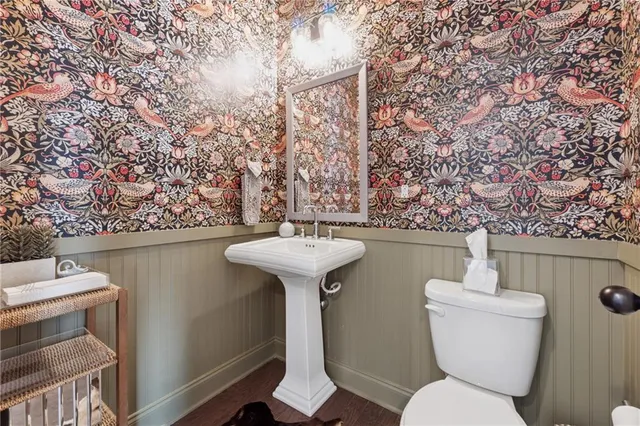a bathroom with a toilet sink and mirror