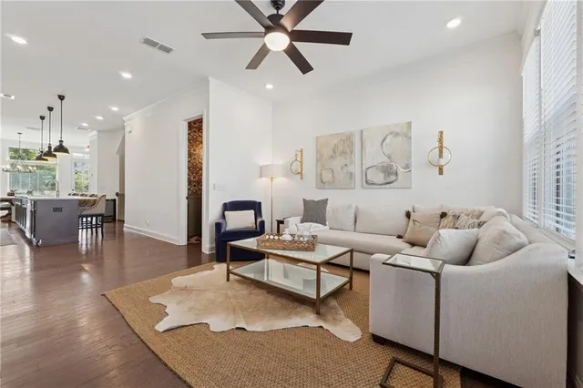 a living room with furniture and a wooden floor