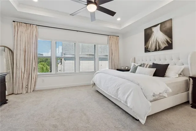 a bedroom with a large bed and a window