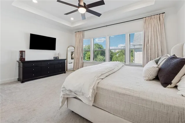 a bedroom with a bed window and a flat screen television
