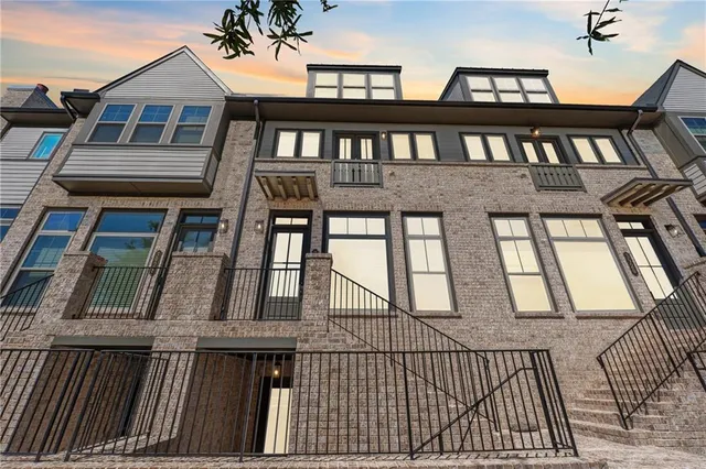 a view of a brick house with large windows