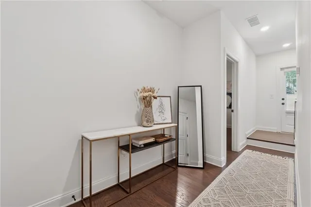 a kitchen with stainless steel appliances a refrigerator and wooden floor