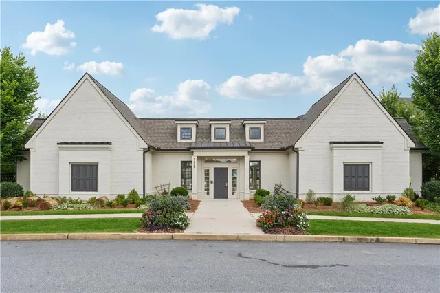 a front view of house with yard and green space