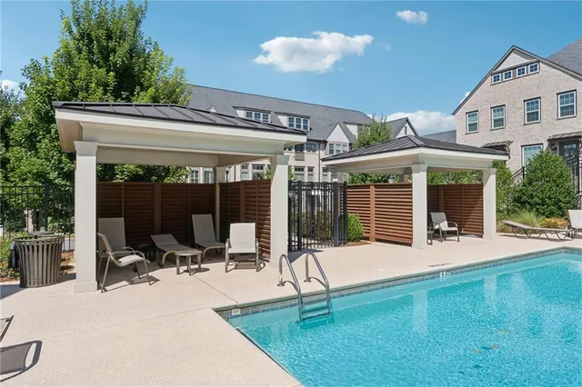 a view of a house with backyard porch and sitting area