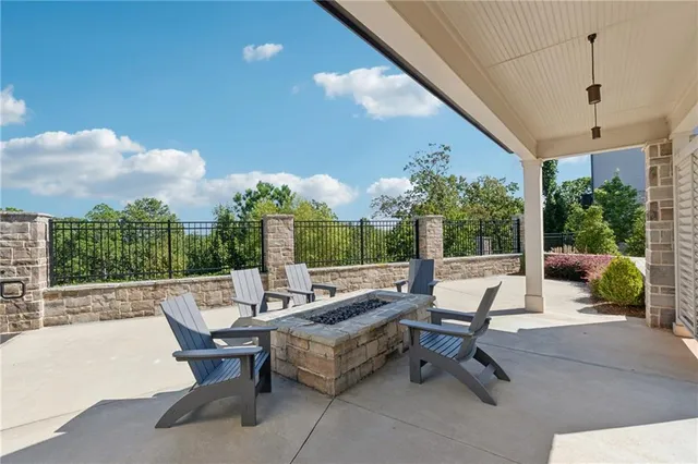 a living room with patio furniture and a potted plants