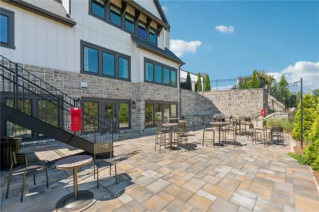 a view of a patio with a table and chairs and potted plants