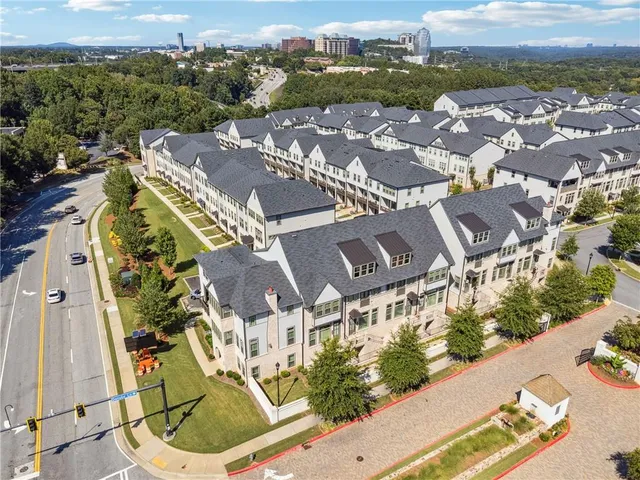 an aerial view of residential houses with outdoor space