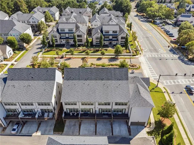 an aerial view of a swimming pool with outdoor seating