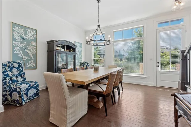 a dining room with furniture window and wooden floor