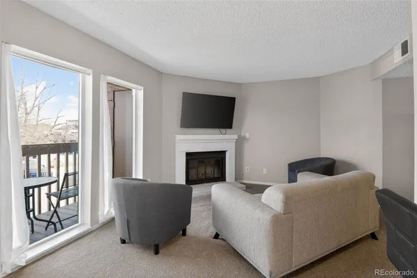 a living room with furniture and a fireplace