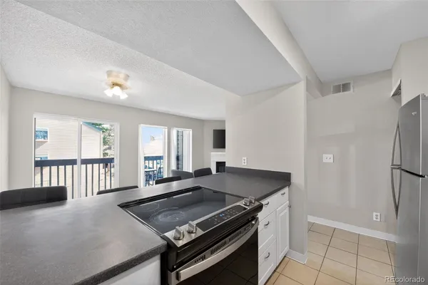 a kitchen with stainless steel appliances granite countertop a stove a refrigerator and a sink