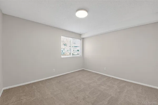 an empty room with a fan