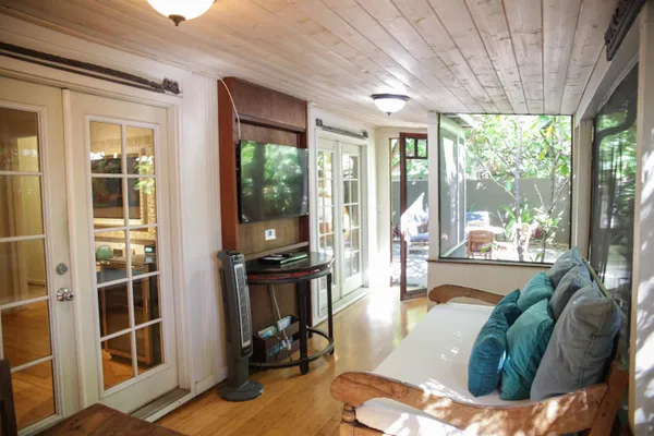 a living room filled with furniture and large windows