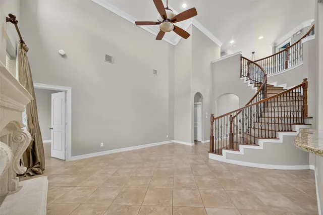 a view of a room with wooden floor a ceiling fan and window