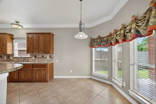 a large kitchen with stainless steel appliances granite countertop a stove and a sink
