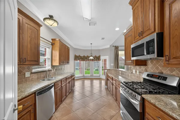 a kitchen with a sink and a large window