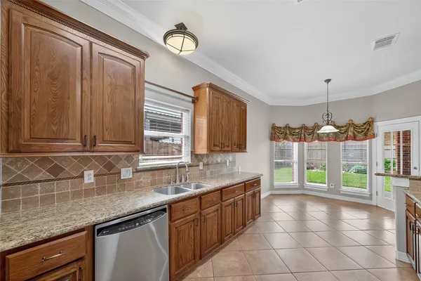 a kitchen with a stove a sink and a microwave