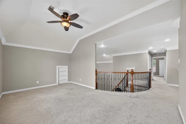 a view of an empty room with a ceiling fan