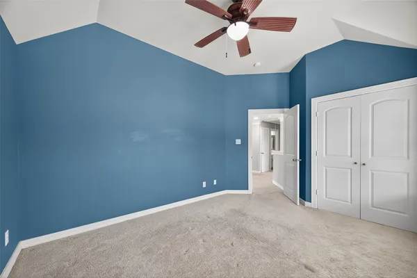 a view of a livingroom with a ceiling fan and window