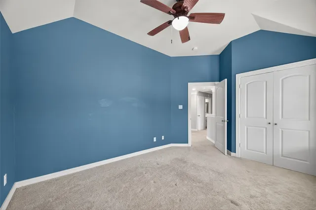 a view of a livingroom with a ceiling fan and window