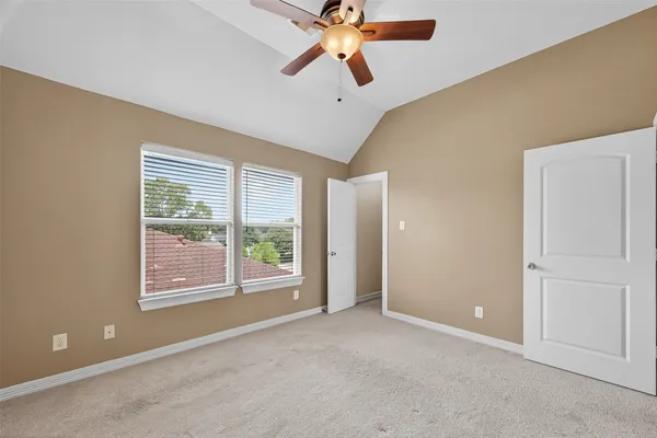 an empty room with chandelier fan