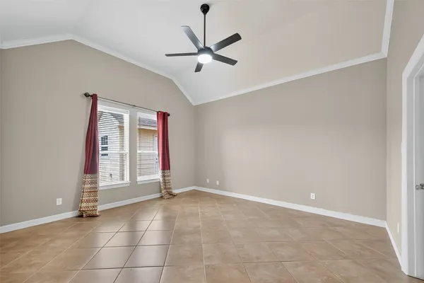a view of an empty room with a fireplace and a fan