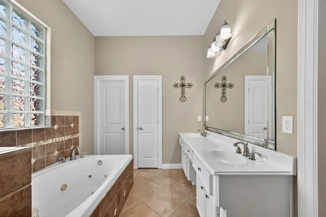 a bathroom with a double vanity sink a mirror and a shower