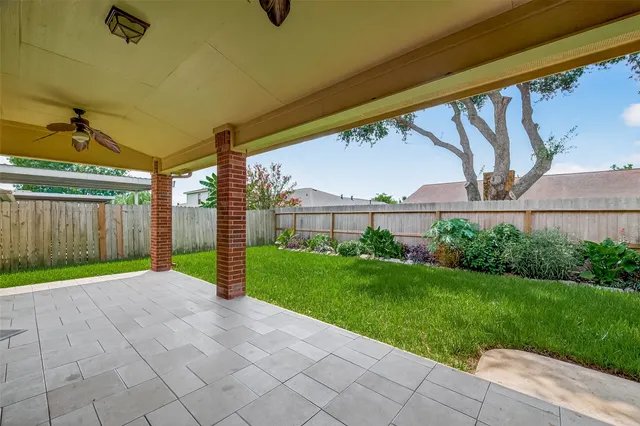 a front view of a house with a yard and fence