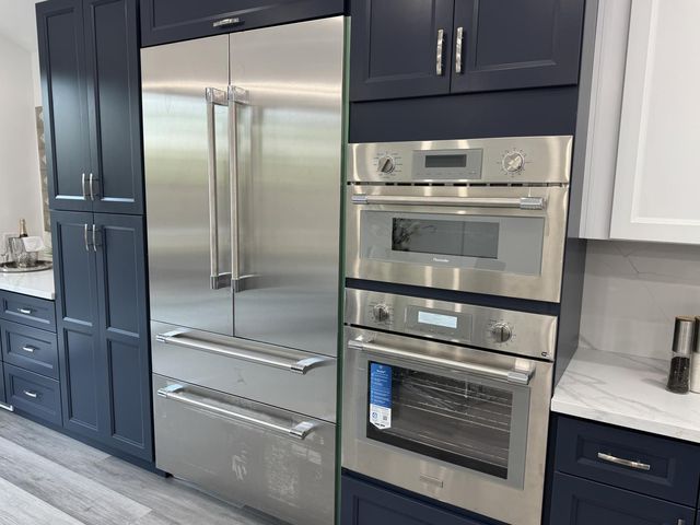 a kitchen with cabinets and stainless steel appliances