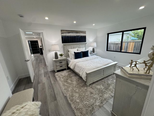 a bedroom with a bed and a television