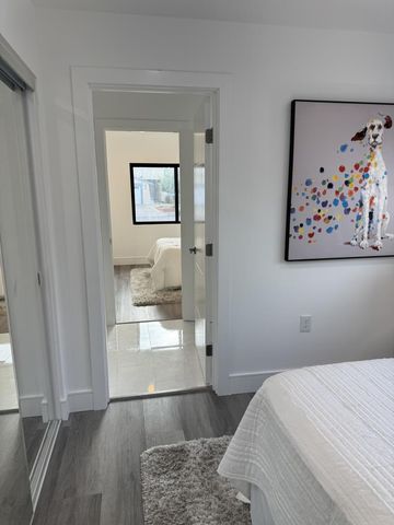 a bedroom with a bed and painting on the wall