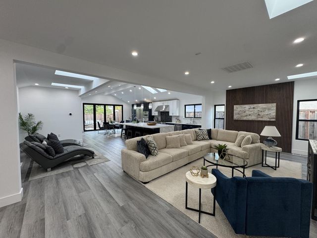 a living room with furniture or wooden floor and a large window