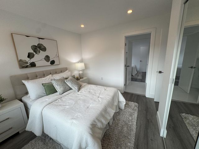 a bathroom with a granite countertop toilet a sink and shower