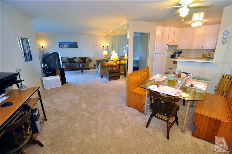 2901 Peninsula Road, Unit 331 Oxnard, CA 93035 - Photo 3 of 21 a bed room with furniture and a chandelier