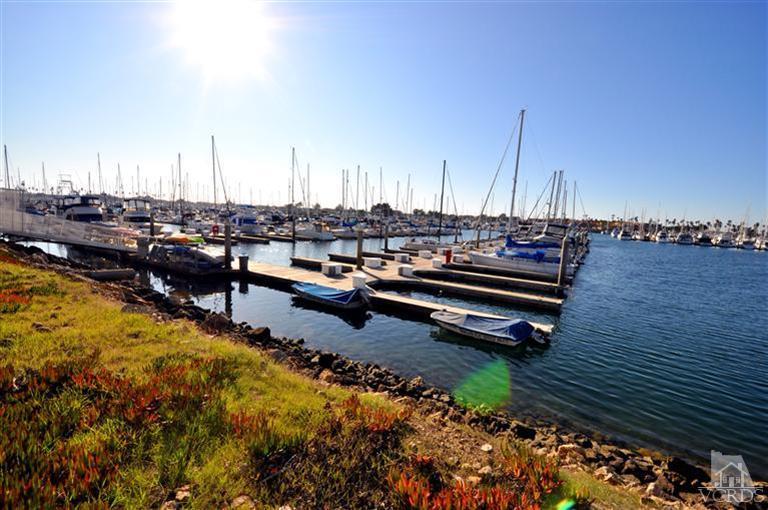 2901 Peninsula Road, Unit 331 Oxnard, CA 93035 - Photo 21 of 21 a view of a lake with boats and palm trees