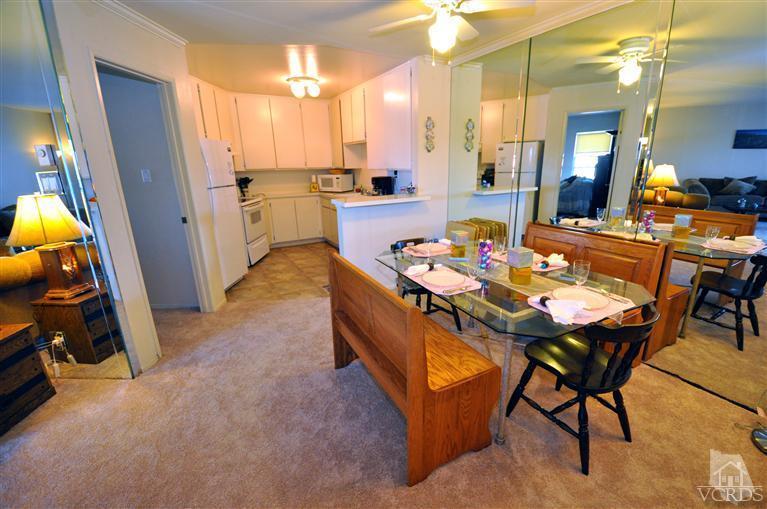 2901 Peninsula Road, Unit 331 Oxnard, CA 93035 - Photo 4 of 21 a dining room with furniture and a chandelier