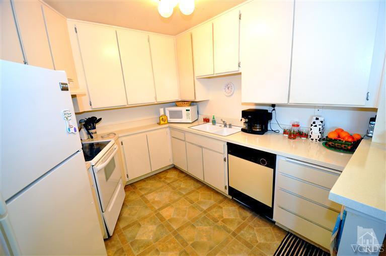 2901 Peninsula Road, Unit 331 Oxnard, CA 93035 - Photo 6 of 21 a kitchen with a sink appliances cabinets and a window