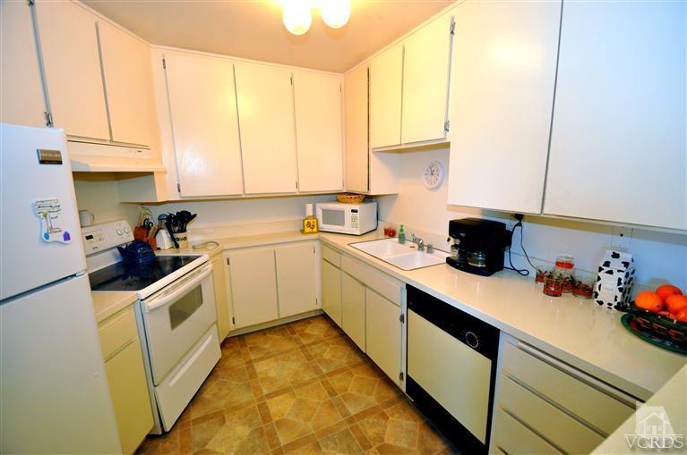 2901 Peninsula Road, Unit 331 Oxnard, CA 93035 - Photo 7 of 21 a kitchen with a sink a stove and cabinets