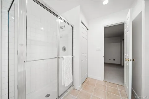 a bathroom with a shower and a glass door