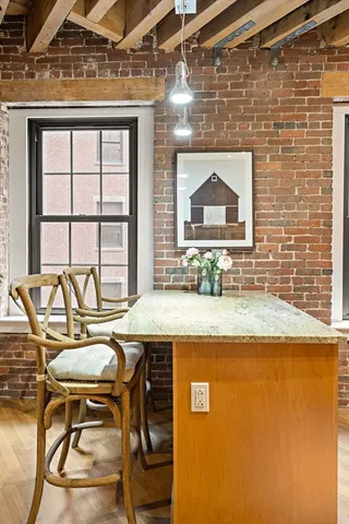 a kitchen with a table chairs a stove and a microwave