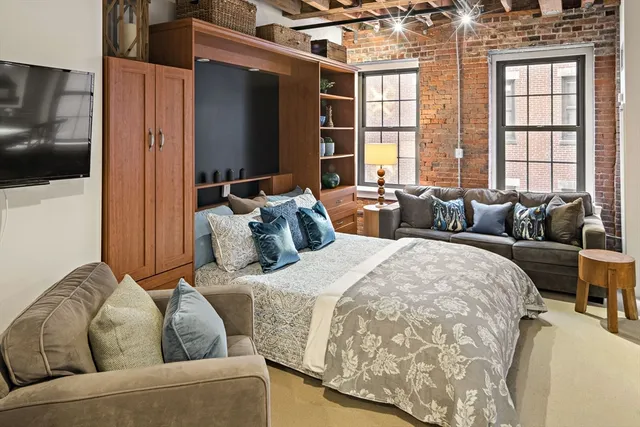 a bedroom with bed and glass door