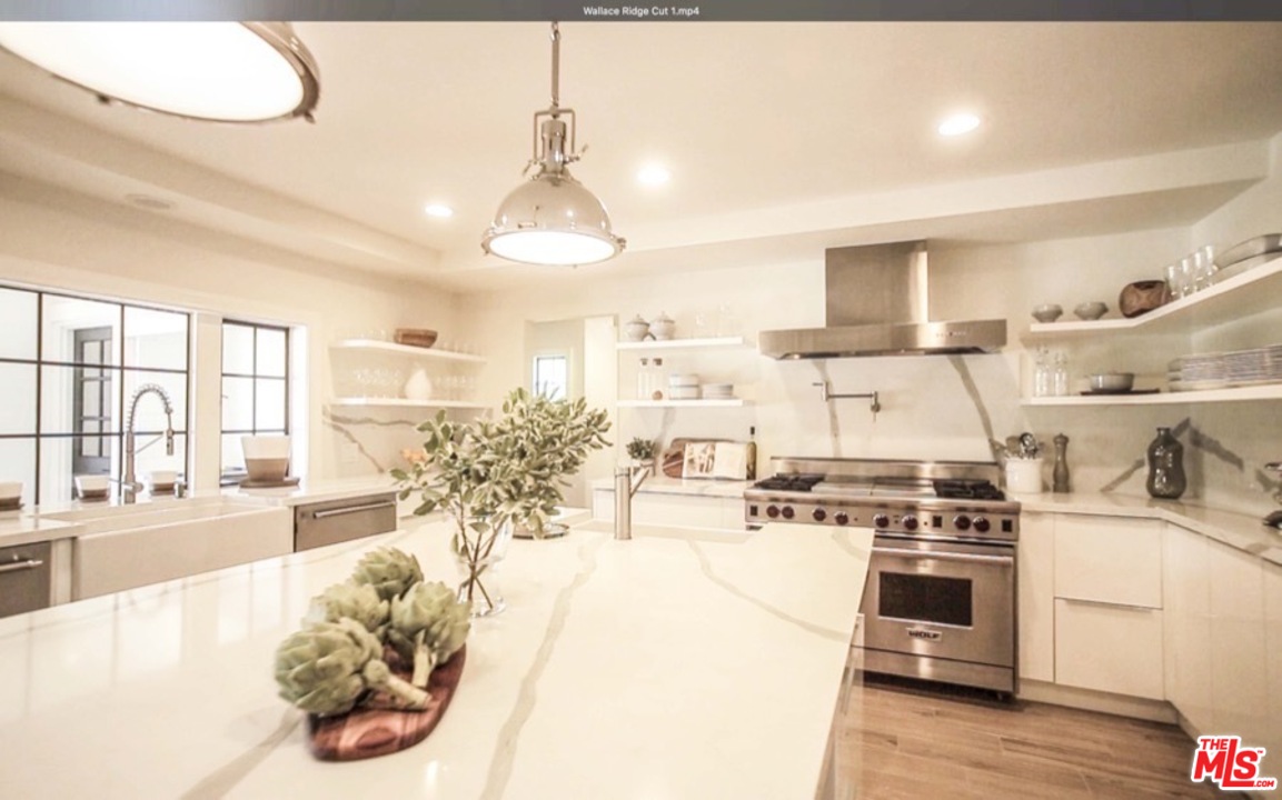 1075 Wallace Ridge Beverly Hills, CA 90210 - Photo 14 of 35 a kitchen with stove and white cabinets
