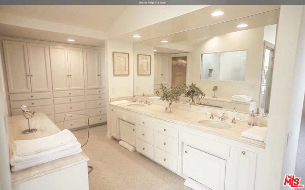 1075 Wallace Ridge Beverly Hills, CA 90210 - Photo 22 of 35 a bathroom with double vanity sink and mirror