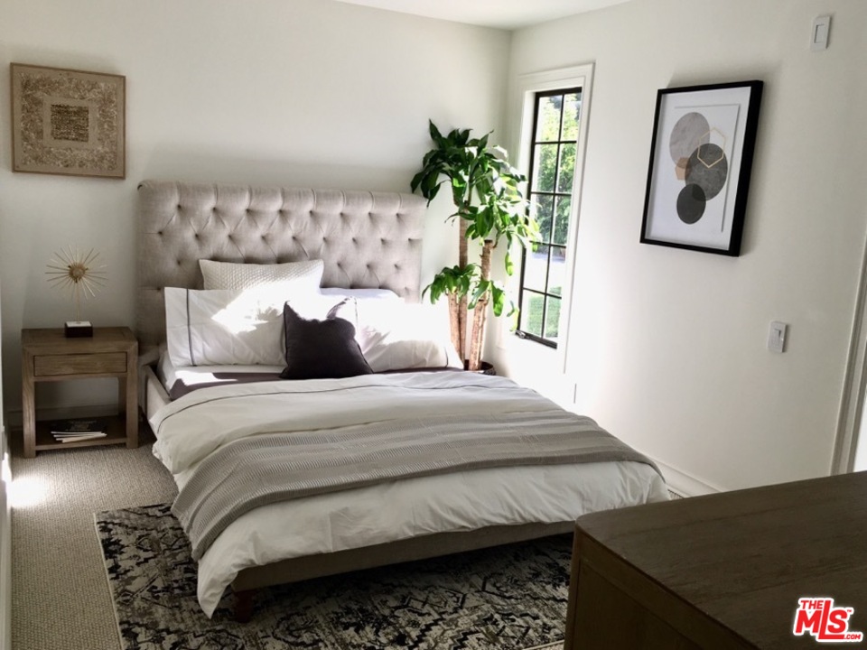 1075 Wallace Ridge Beverly Hills, CA 90210 - Photo 26 of 35 a bedroom with a bed and a painting on the wall