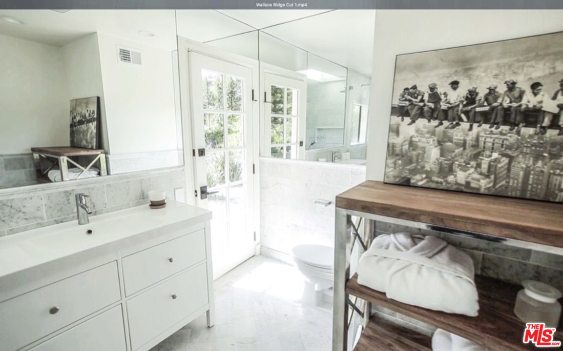 1075 Wallace Ridge Beverly Hills, CA 90210 - Photo 27 of 35 a bathroom with a sink and a mirror